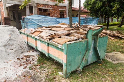 Construction site with builders waste ready for clearance in Millbank